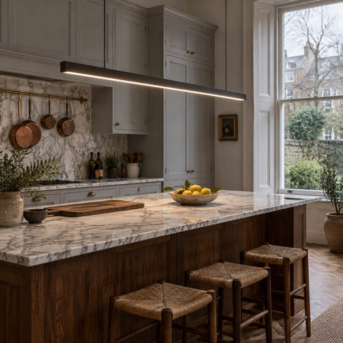 Aplomb linear LED pendant over a marble kitchen island