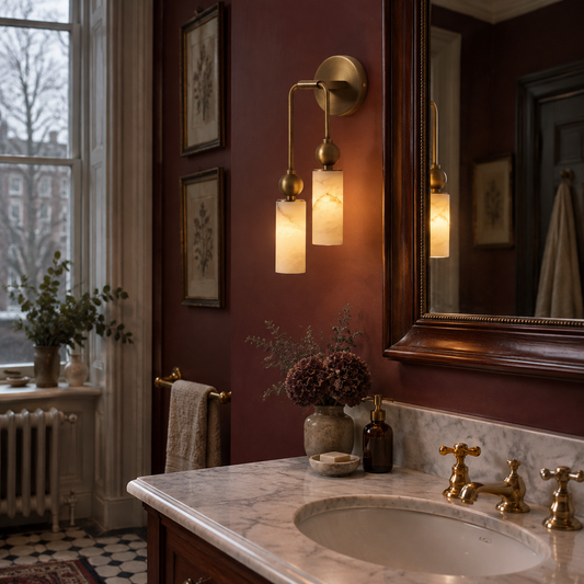 Brass alabaster wall sconce beside a bathroom mirror