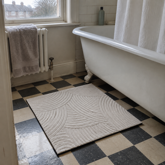 Non-slip bath mat on the floor of a 1930s family bathroom