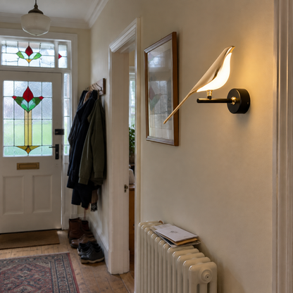 Acrylic bird wall light in a 1930s hallway