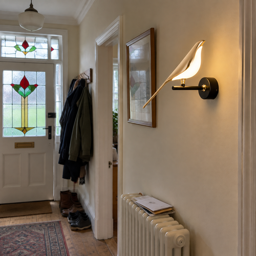 Acrylic bird wall light in a 1930s hallway