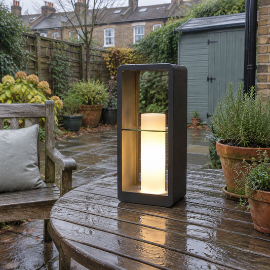 Black rectangular outdoor lantern on a garden patio