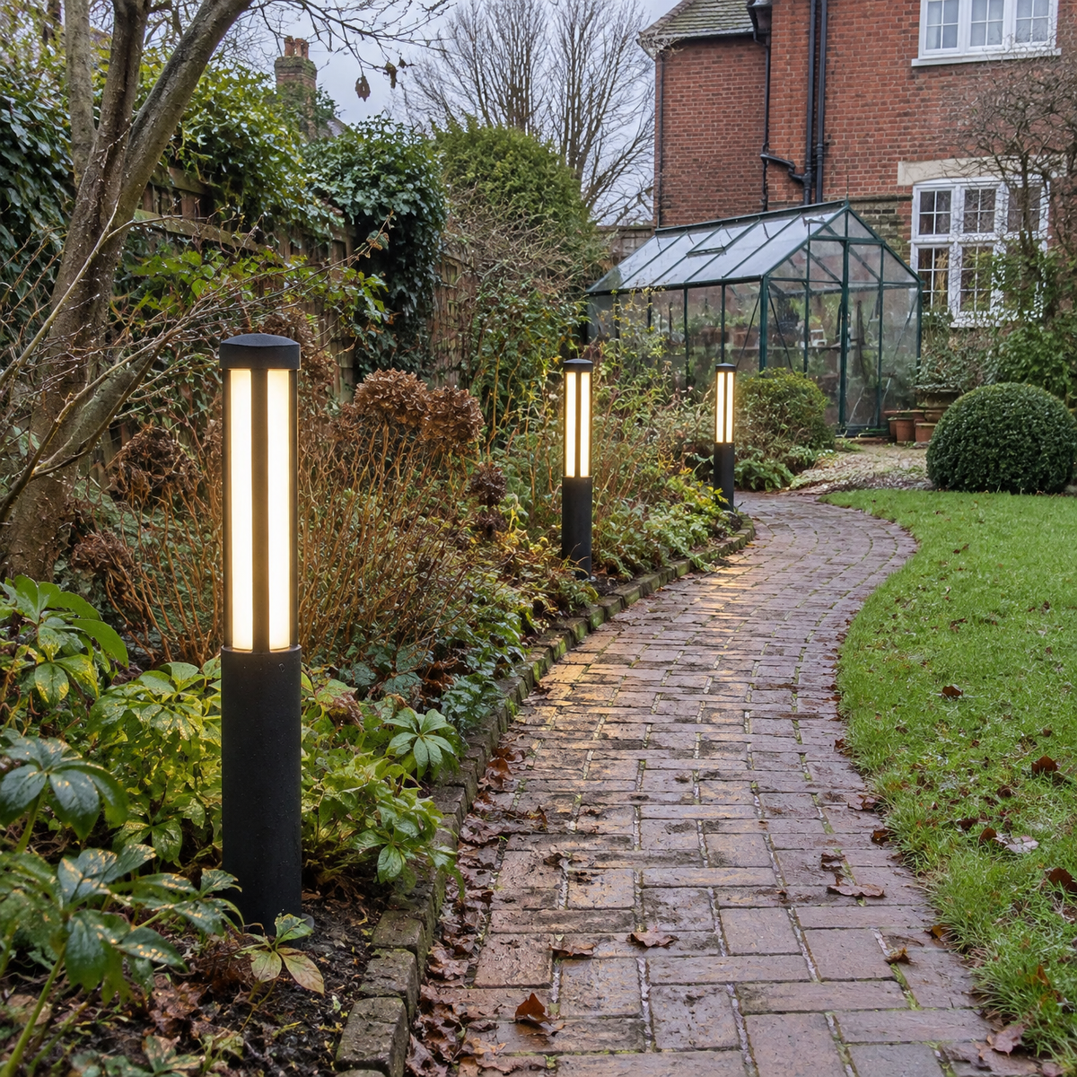 Cylindrical bollard lights along a brick garden path