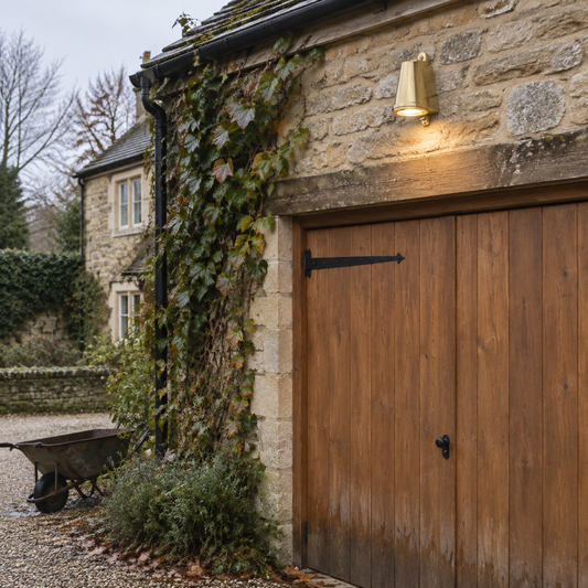Brass barn outdoor wall light on a stone cottage