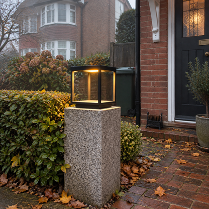 Concrete pillar light beside a front garden path