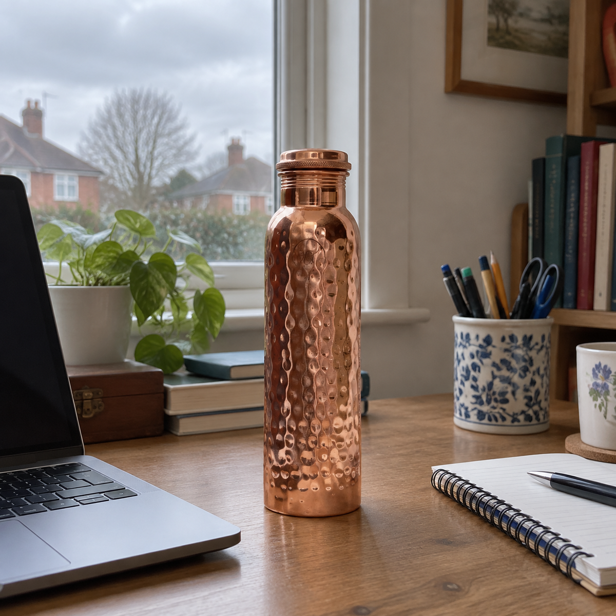 Hammered copper water bottle on a desk
