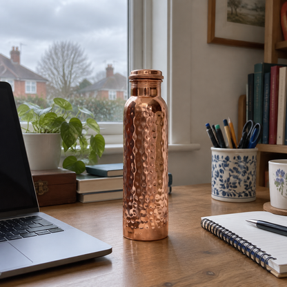 Hammered copper water bottle on a desk