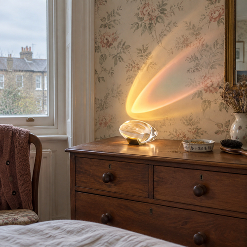 Crystal glass table lamp on a chest of drawers