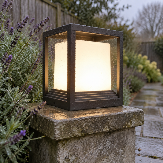 Square LED garden pedestal post light beside a garden path