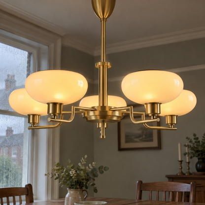 Gold metal and glass chandelier over a dining table