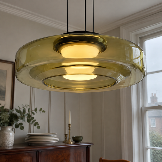 Layered glass pendant light above a dining room sideboard