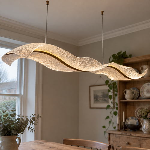 Dimmable acrylic linear LED dining light hanging low over a British dining table
