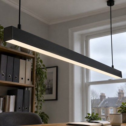 Black linear LED pendant bar hanging above a British home office desk