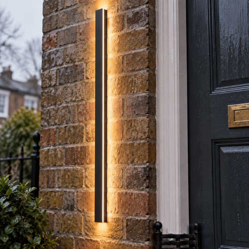 Minimalist black linear LED outdoor wall sconce beside a British front door in drizzle