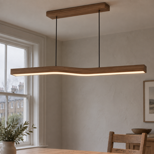 Minimalist metal linear LED pendant hanging above a British dining table