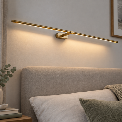 Minimalist linear bedside wall light mounted above a British bed in soft grey daylight