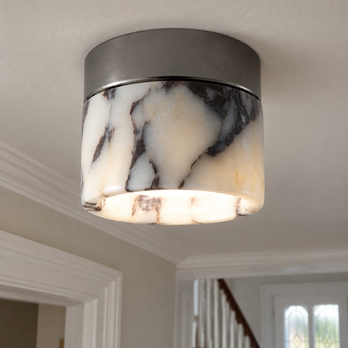 Round marble minimalist flush mount ceiling light fitted to a British hallway ceiling