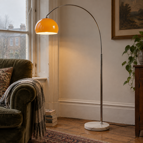 Marble and glass mid-century floor lamp standing beside an armchair in a British sitting room
