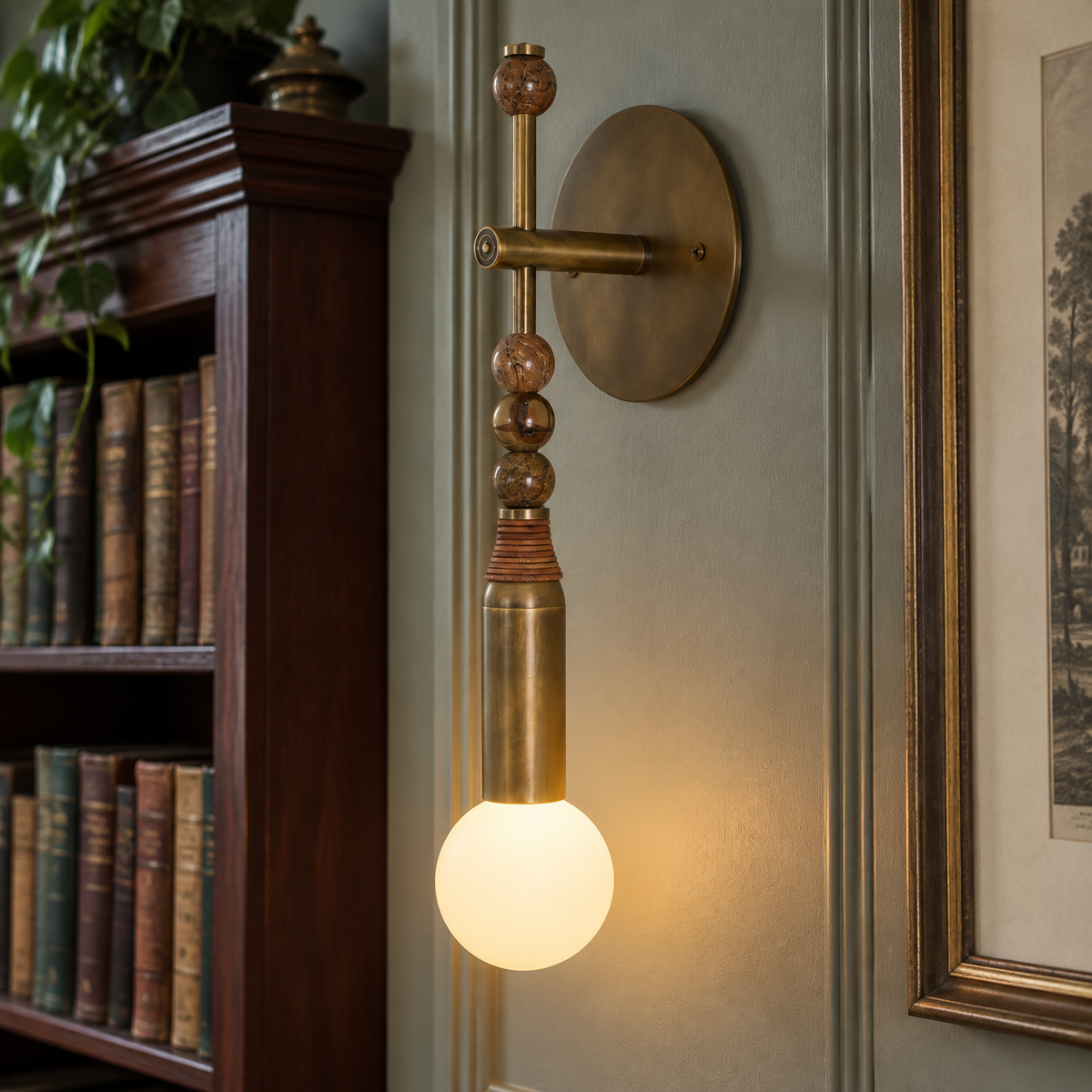 Marble and brass industrial wall sconce mounted on a painted wall in a British hallway