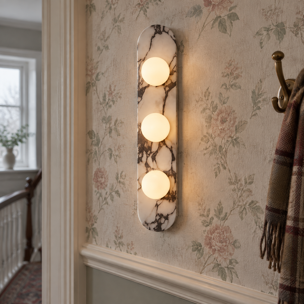 Minimalist natural stone wall sconce on a plastered wall in a British bedroom