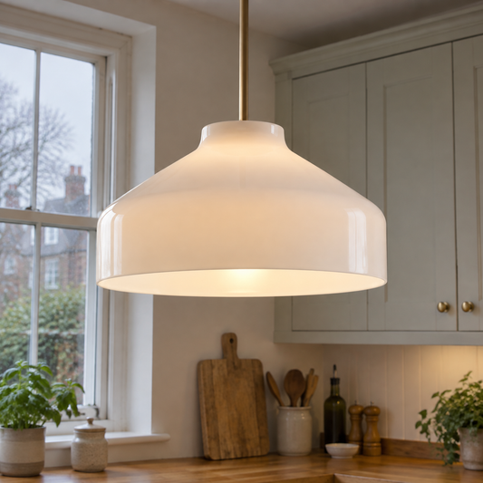 Matte metal Nordic pendant light hanging above a kitchen worktop in a British home