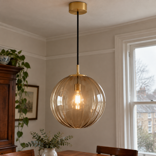 Mid-century glass and metal pendant light hanging in a British kitchen