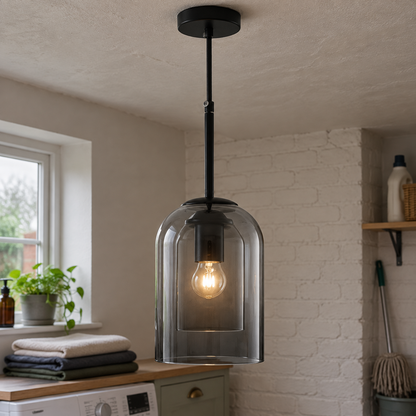 Industrial mid-century glass and metal pendant light above a British dining table