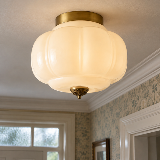 Vintage milk glass semi-flush ceiling light fixed to a British hallway ceiling