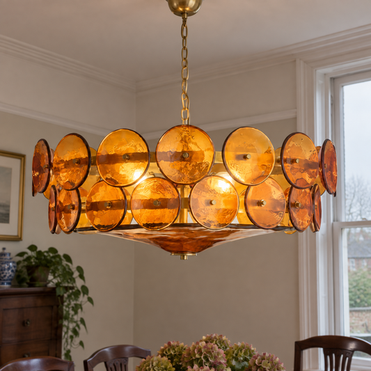 Murano glass and brass chandelier hanging over a dining table in a British dining room