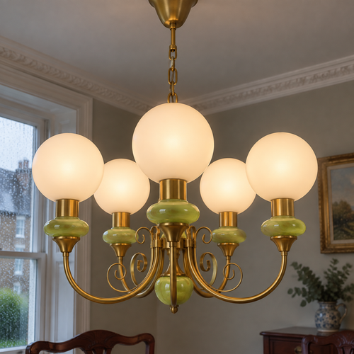 Onyx and agate glass chandelier hanging above a dining table beneath plaster cornicing