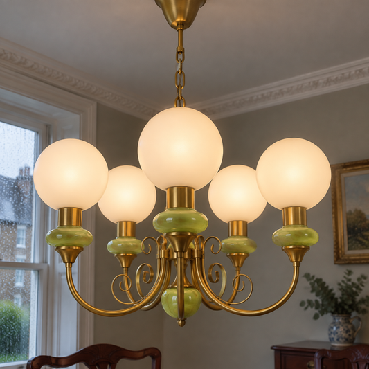 Onyx and agate glass chandelier hanging above a dining table beneath plaster cornicing