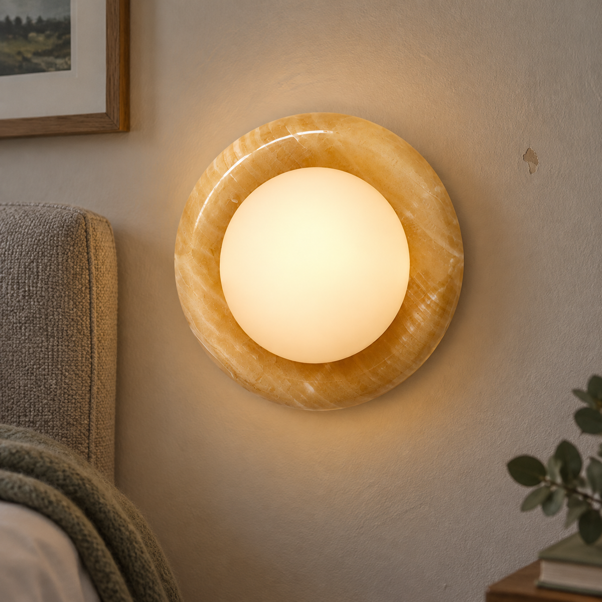 Natural stone jade wall sconce lit above an upholstered headboard in a bedroom