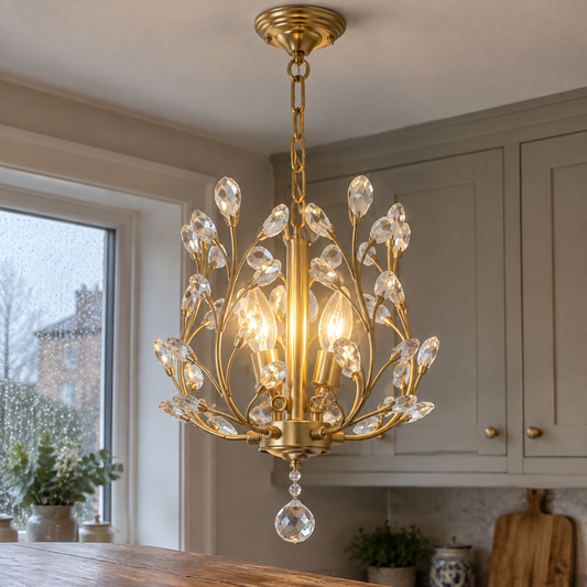 Modern pendant ceiling light hanging lit above a kitchen island with shaker cupboards