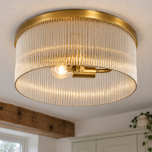 Ribbed glass farmhouse flush mount ceiling light glowing against a kitchen ceiling beam