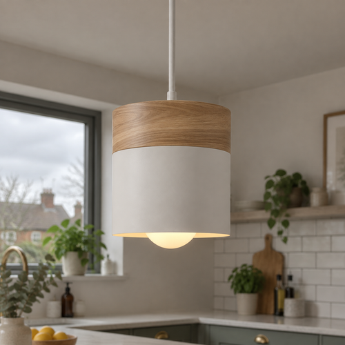 Small Scandi wood and coloured metal pendant light hanging over a kitchen island worktop