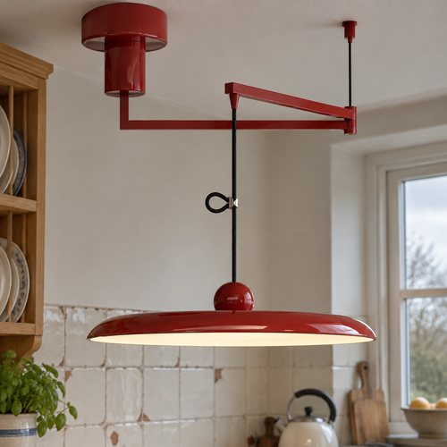 Retro disc swing arm pendant light hanging over a kitchen worktop beside a chipped enamel splashback tile