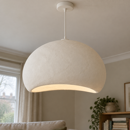 Handmade off-white wabi-sabi cloud pendant lampshade hanging above a linen sofa in a misty sitting room