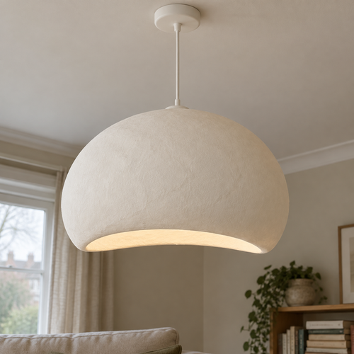 Handmade off-white wabi-sabi cloud pendant lampshade hanging above a linen sofa in a misty sitting room