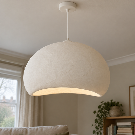 Handmade off-white wabi-sabi cloud pendant lampshade hanging above a linen sofa in a misty sitting room