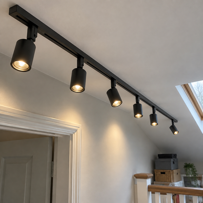 Long black track with six widely spaced spotlights running down a loft landing ceiling