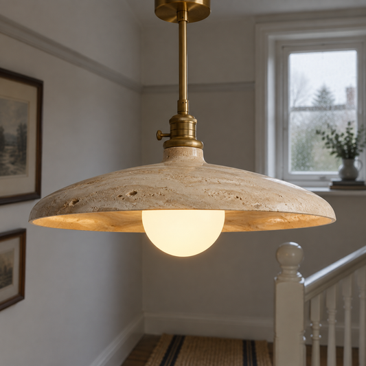 Round Scandinavian travertine pendant light on a stair landing, beige stone shade hanging above a painted bannister and worn floor runner