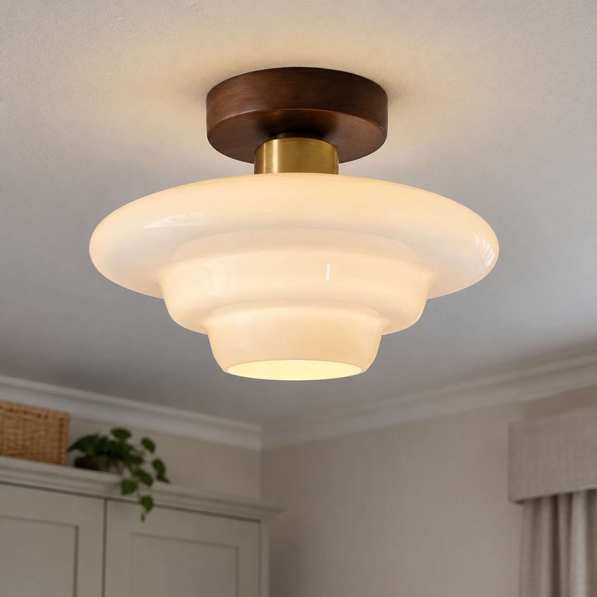 Scandinavian walnut and glass ceiling light fitted flush to a bedroom ceiling, warm wood frame with glass diffuser lit softly