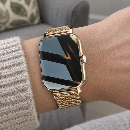 Women's smart watch worn on a wrist turned to glance at the face, beside a fabric sofa arm and cushion