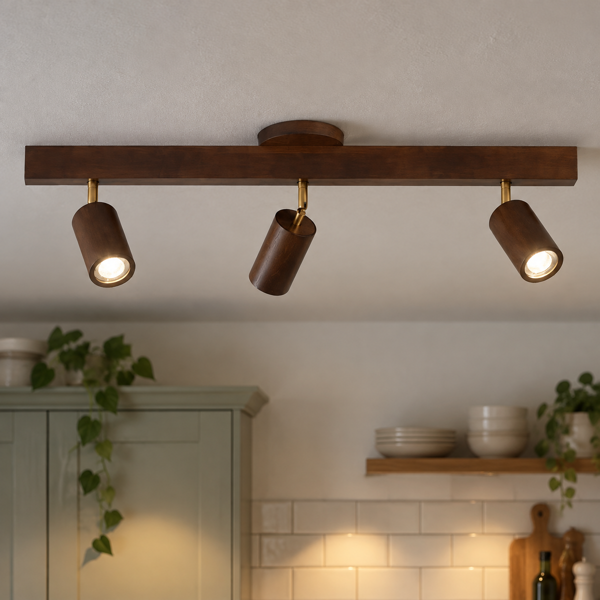 Wooden ceiling spotlight track bar fixed level to a kitchen ceiling, heads angled down over the worktop