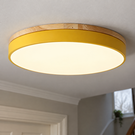 Round wooden LED flush mount ceiling light fitted flat to a landing ceiling, timber rim around a warm white diffuser
