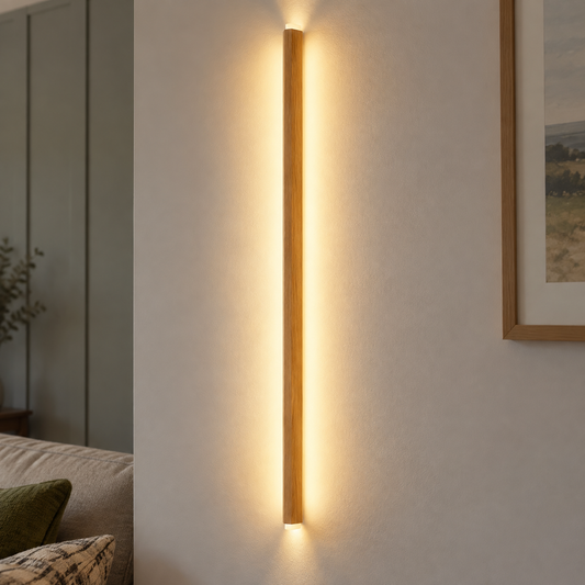 Long wooden up and down LED wall light bar fixed flush to a panelled sitting room wall, warm washes above and below