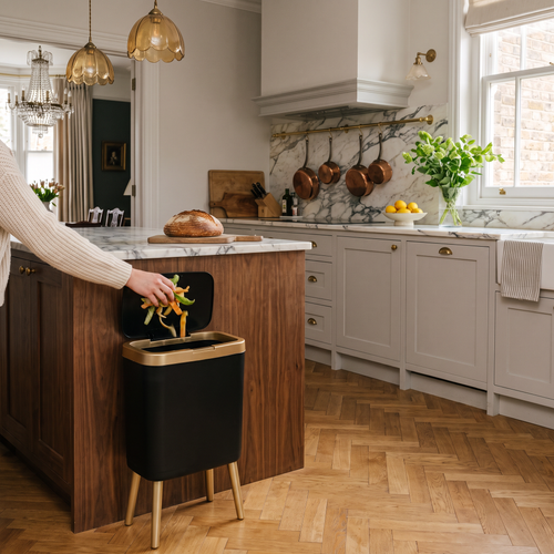 15L odour-sealing waste bin with elevated legs in a heritage kitchen with marble and copper pans